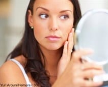 Model with brown hair looking in the mirror