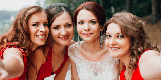 bride and bridesmaids looking at camera