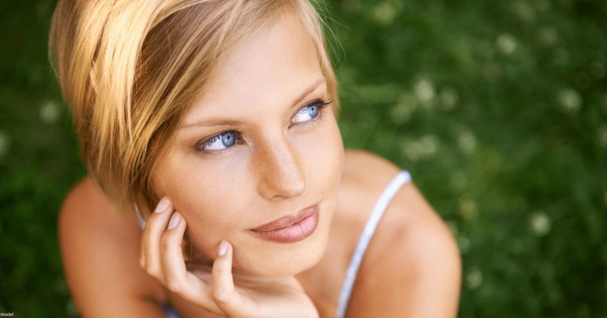 Attractive young woman looking pensive to the right