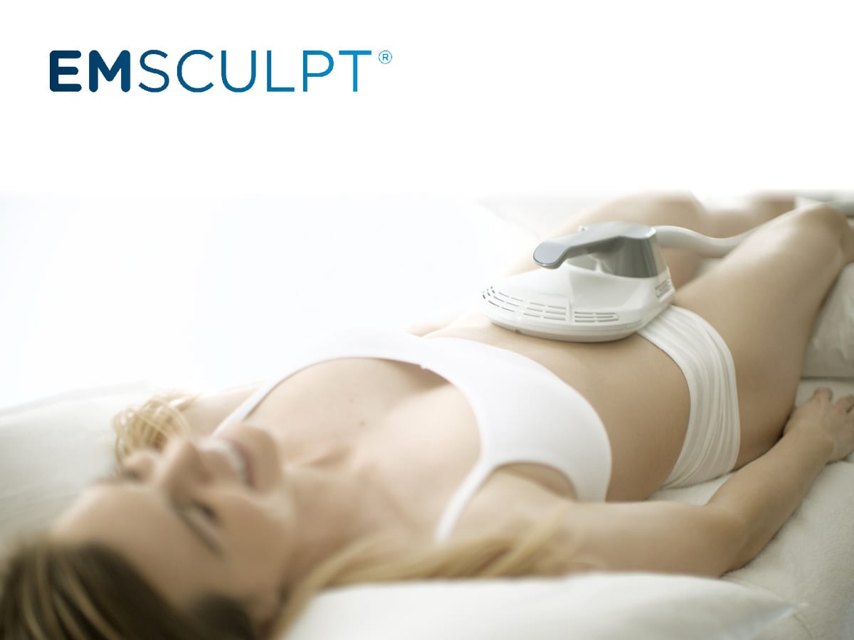 Woman receiving an EMSCULPT treatment on her stomach