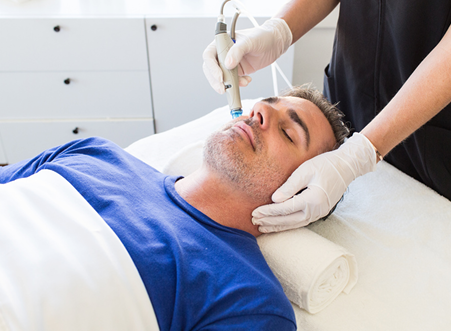 man receiving hydrafacial treatment